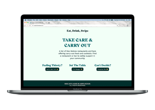 A laptop displays a website