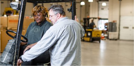 Two individuals in a warehouse setting